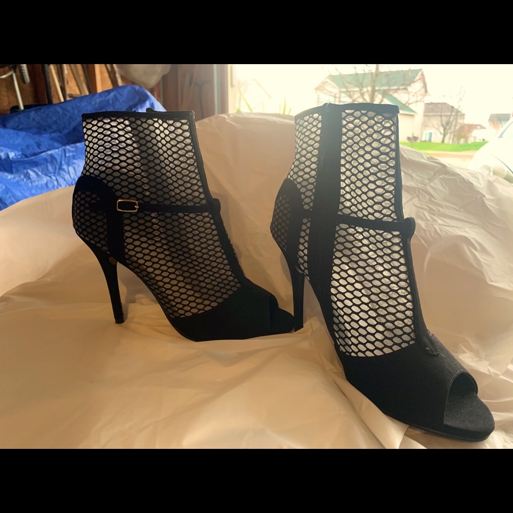Black suede bootie with toe out and side zipper.